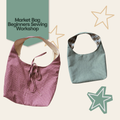 Two fabric market bags shown on a light beige background with decorative star outlines and a teal label reading 'Market Bag, Beginners Sewing Workshop.' The left bag has a pink-and-white gingham pattern and a drawstring closure, while the right bag is a muted sage green fabric with a plaid interior lining.
